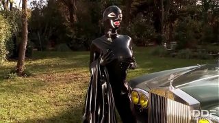 Fetish Queen Latex Lucy takes her rubber-clad body outdoors, sliding a thick dildo deep into her wet cunt